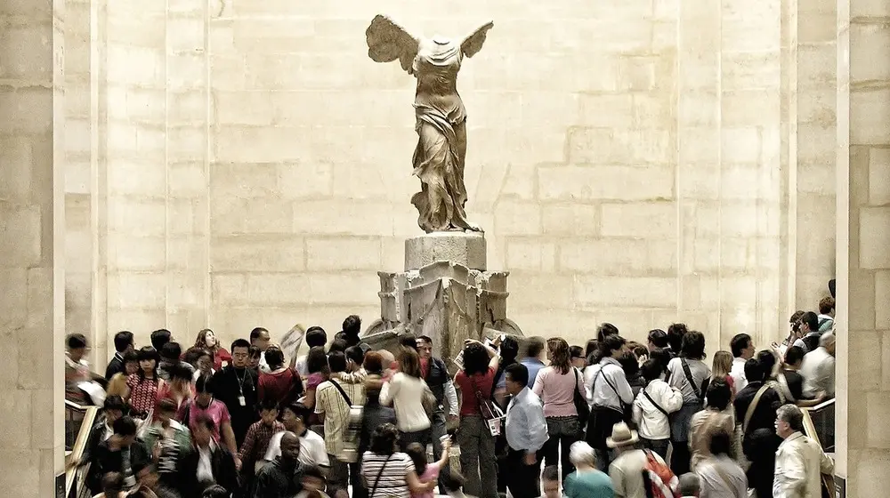 mass tourism needs to die. image of tourists in Louvre